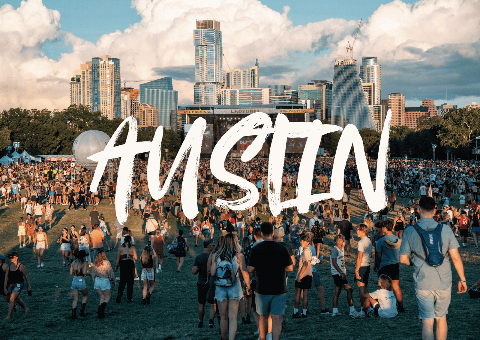 Crowd cheering under colorful stage lights at a live concert in Austin.