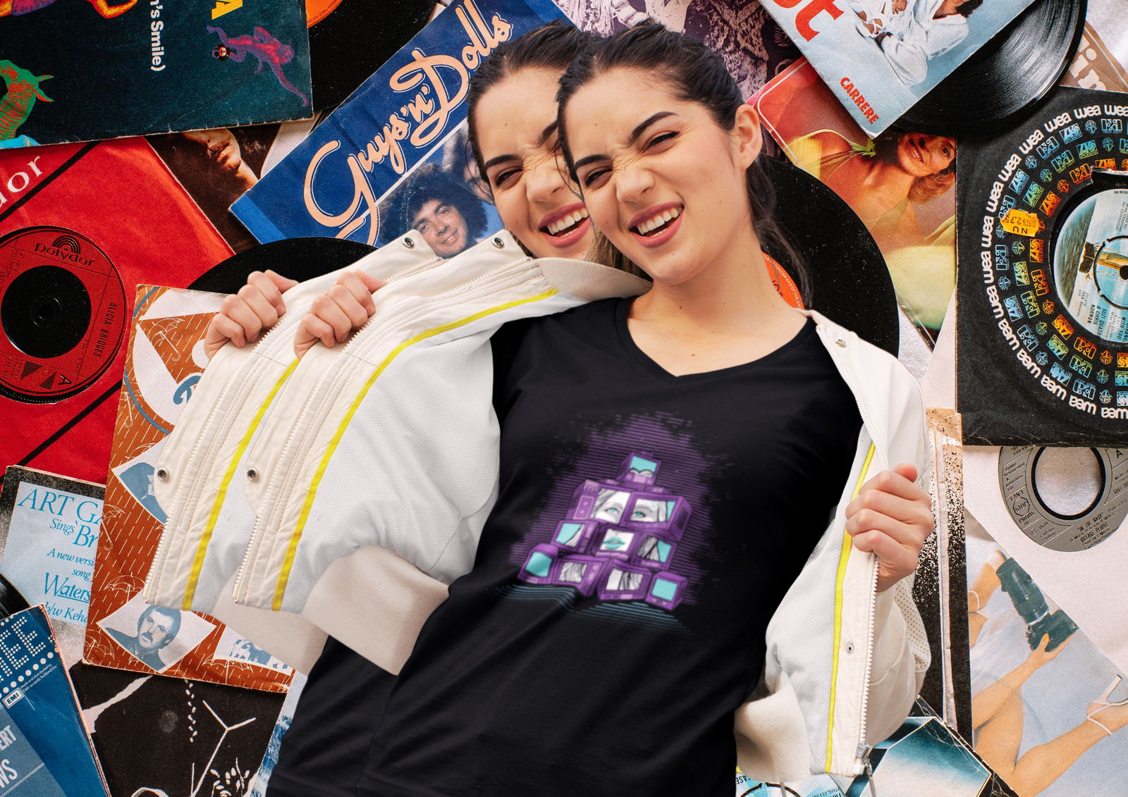 Smiling woman posing in a Sky Titan “Screens” graphic tee, unzipping her jacket to reveal the bold, purple TV stack design—set against a vibrant collage of vintage vinyl records and retro album covers.