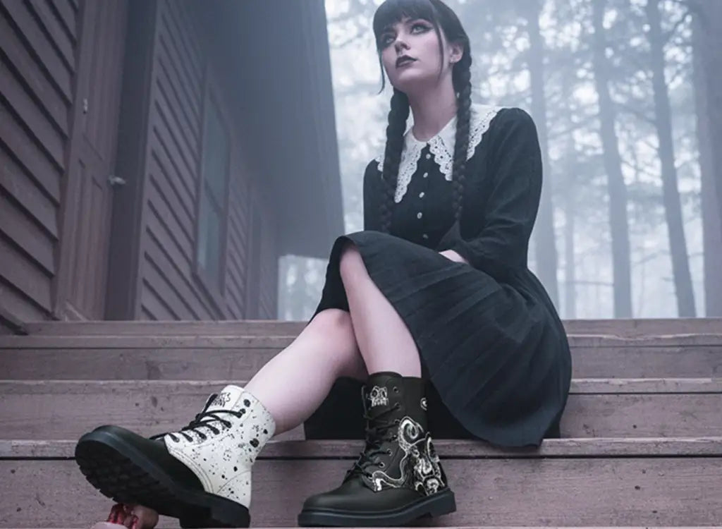 A woman dressed in a black dress wearing black and white mismatched combat boots with an octopus design from Sky Titan Media