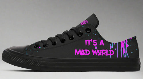 Black low-top sneakers featuring neon pink text reading “IT’S A MAD WORLD” on the outer side of the left shoe, set against a backdrop of chaotic pink splatter art. Matte black midsole, toe cap, and eyelets create a clean base that lets the pink design stand out. Cyber Cat design by Sky Titan Media, blending futuristic vibes with bold, music-infused streetwear energy.