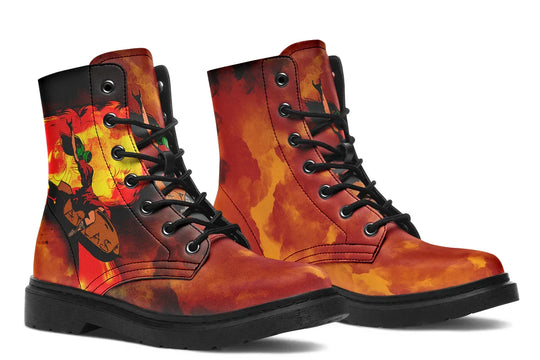 Black lace-up boots featuring asymmetrical design: the outer side of the right boot displays a bold, vintage-style Bomber Girl illustration — a pin-up pilot surrounded by an explosive orange-yellow sky — while the left boot showcases only the textured smoke gradient. Black soles, metal eyelets, and laces frame the fiery red-orange canvas. — Bomber Girl design by Sky Titan Media, combining vintage military-inspired art with edgy, music-fueled streetwear flair.