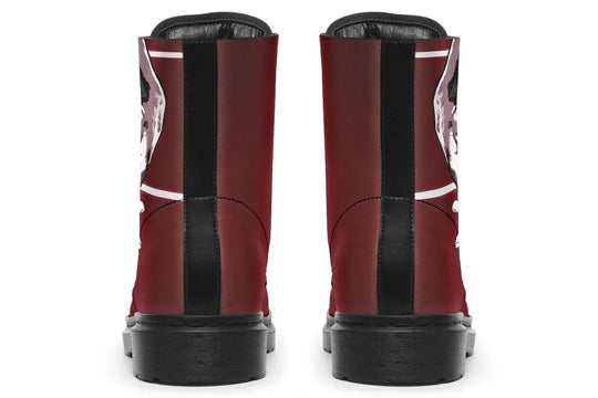 Red lace-up leather boots showcasing expressive line art of two reaching hands from the “July” single cover – July Edition by Sky Titan Media, blending raw emotional symbolism with bold, music-driven streetwear design.From behind, the boots split like chapters. One heel continues the artwork, the other is bare. A black vertical line bisects the red—like a scar or separation. 
