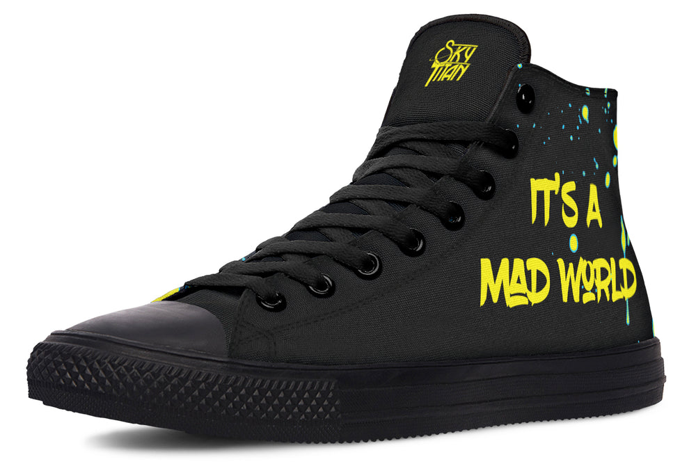 Left-side view of Cyber Cat Yellow Edition sneaker with graffiti-style “It’s A Mad World” text in glowing yellow over black splatter and glitch textures. The left shoe delivers the anthem—“It’s A Mad World” etched in jagged yellow graffiti across matte black chaos. A signature Sky Titan statement that turns rage into art, noise into motion, and rebellion into rhythm.