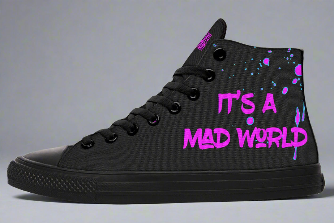 Black high-top sneakers with striking pink neon cyber cat artwork on the sides – Cyber Cat Pink Edition by Sky Titan Media, blending fierce futuristic style with bold, music-driven streetwear attitude.
On the left outer panel, the sneaker wears its message loud and proud: “It’s A Mad World” scrawled in neon-pink graffiti over layered paint splashes. The phrase becomes a manifesto—where fashion meets music, rebellion, and digital-age chaos.