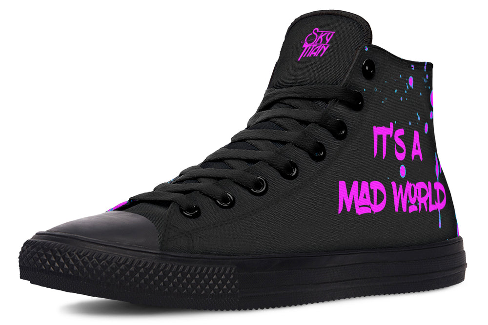 Black high-top sneakers with striking pink neon cyber cat artwork on the sides – Cyber Cat Pink Edition by Sky Titan Media, blending fierce futuristic style with bold, music-driven streetwear attitude.
On the left outer panel, the sneaker wears its message loud and proud: “It’s A Mad World” scrawled in neon-pink graffiti over layered paint splashes. The phrase becomes a manifesto—where fashion meets music, rebellion, and digital-age chaos.