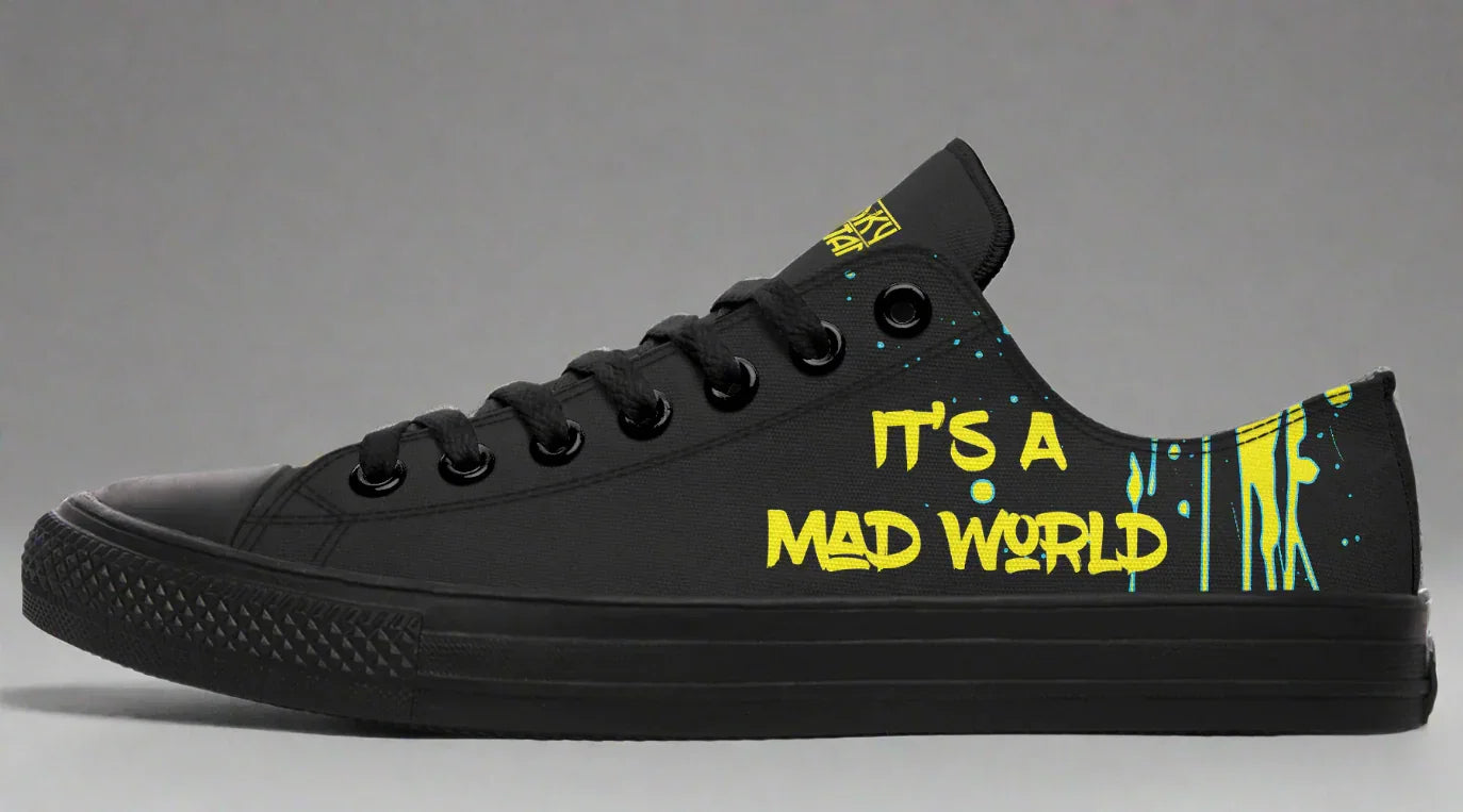 Black low-top sneakers featuring bold yellow text reading “IT’S A MAD WORLD” on the outer side of the left shoe. Surrounded by paint strokes and splashes in teal and yellow, the design evokes chaotic creativity on a deep black background. Cyber Cat design by Sky Titan Media, blending futuristic vibes with bold, music-infused streetwear energy.