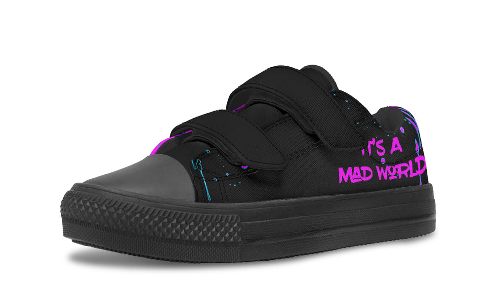 Black low-top sneakers for kids with bold cyber cat graphics, graffiti slogans, and a street-tough silhouette — now with easy Velcro straps for active little rebels.
The left shoe shows off pure punk: “It’s A Mad World” pops in pink across the side. Black straps and black toe box let the wild words take center stage.