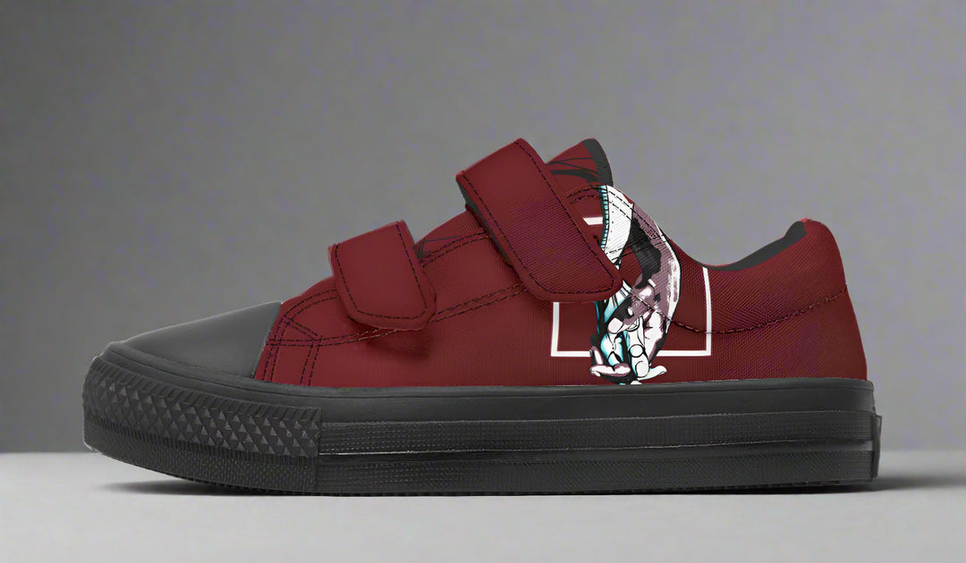 Studio shot of the “July” kids’ sneaker by Tatiana Jitkoff and Sky Titan Media, capturing the full outer artwork of two reaching hands in fine white line art – a tribute to connection, creativity, and the art of growing up with story-driven style.