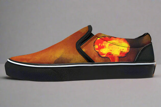 Black slip-on sneaker featuring a red-orange smoke explosion blast on the outer canvas of the left shoe, with no figure artwork. Framed in black trim and grounded by a clean black sole — Bomber Girl design by Sky Titan Media, merging vintage attitude with edgy, music-fueled streetwear style.