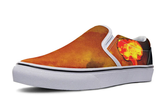 Black slip-on sneaker featuring a red-orange smoke explosion on the outer canvas, framed with white binding and set above a crisp white midsole. A clean contrast that highlights the artwork without overpowering it. — Bomber Girl design by Sky Titan Media, merging vintage attitude with edgy, music-fueled streetwear style.
