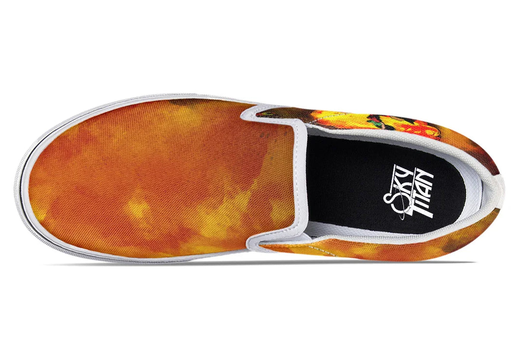 Black slip-on sneakers featuring vivid red-orange smoke artwork across both uppers, with white piping, white inner panels, and a white midsole adding contrast and edge. Sky Titan branding visible on the insole. — Bomber Girl design by Sky Titan Media, merging vintage attitude with edgy, music-fueled streetwear style.