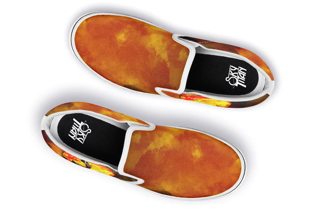 Black slip-on sneakers featuring vivid red-orange smoke artwork across both uppers, with white piping, white inner panels, and a white midsole adding contrast and edge. Sky Titan branding visible on the insole. — Bomber Girl design by Sky Titan Media, merging vintage attitude with edgy, music-fueled streetwear style.