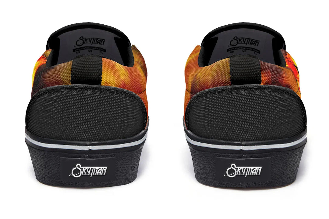 Black slip-on sneakers featuring reinforced heel panels and black canvas rear with white Sky Titan logo tags. The sides wrap around in red-orange smoke art, tying the asymmetrical design together from behind — Bomber Girl design by Sky Titan Media, merging vintage attitude with edgy, music-fueled streetwear style.