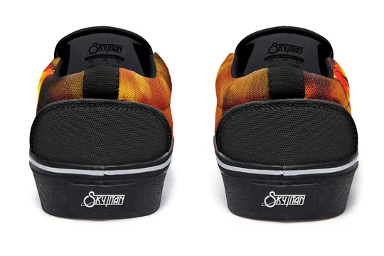 Black slip-on sneakers featuring reinforced heel panels and black canvas rear with white Sky Titan logo tags. The sides wrap around in red-orange smoke art, tying the asymmetrical design together from behind — Bomber Girl design by Sky Titan Media, merging vintage attitude with edgy, music-fueled streetwear style.