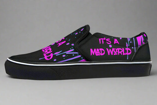 Black slip-on sneakers with bold cyber cat punk artwork and graffiti text – Cyber Cat Pink Edition by Sky Titan Media, blending fierce futuristic style with bold, music-driven streetwear attitude.
This left shoe is a visual protest—its bright pink graffiti text reads “IT’S A MAD WORLD” twice: once across the toe and again along the outer panel. Urban, direct, and unfiltered.