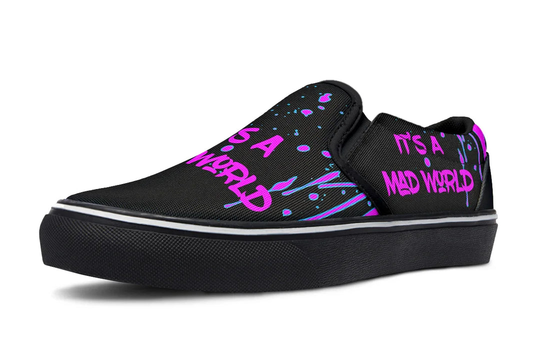 Black slip-on sneakers with bold cyber cat punk artwork and graffiti text – Cyber Cat Pink Edition by Sky Titan Media, blending fierce futuristic style with bold, music-driven streetwear attitude.
This left shoe is a visual protest—its bright pink graffiti text reads “IT’S A MAD WORLD” twice: once across the toe and again along the outer panel. Urban, direct, and unfiltered.
