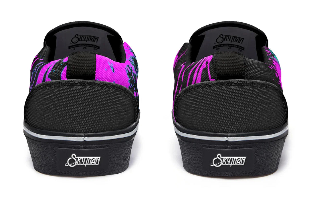 Black slip-on sneakers featuring asymmetrical cyber cat punk artwork and graffiti statements — the Cyber Cat Pink Edition by Sky Titan Media, fusing futuristic street rebellion with bold, music-charged expression.
Seen from behind, the silhouette remains sleek and structured: black canvas heels, clean seam lines, and a white midsole base bring subtle balance to the expressive chaos of the fronts and sides.