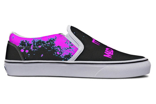 Black slip-on sneakers featuring asymmetrical cyber cat punk artwork and graffiti statements with white detailing — the Cyber Cat Pink Edition by Sky Titan Media, fusing futuristic street rebellion with bold, music-charged expression.
The inner panels tone things down with pink and teal splatter effects—a visual rhythm in motion. With white soles framing the look, the chaos is balanced by clean structure.