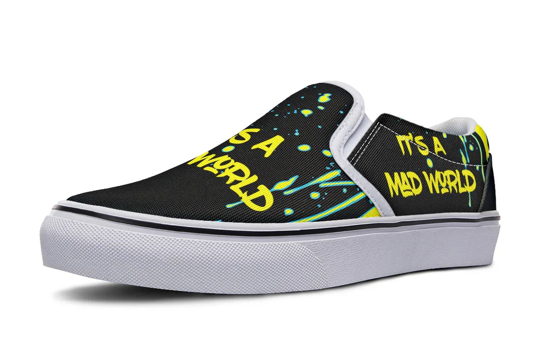 “IT’S A MAD WORLD” blazes across the black canvas in neon graffiti, energized by chaotic yellow paint splatters for a loud, punk-inspired vibe. The clean white sole and stitching ground the frenzy in stylish precision. These black slip-on sneakers feature neon yellow cyber cat graphics and graffiti slogans — Cyber Cat Yellow Edition by Sky Titan Media, built for rebels with futuristic flair and music-fueled streetwear energy.