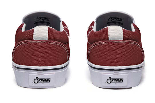 Rear view of the updated “July” slip-ons with clean white soles and distinct heel stitching. Black pull tabs and Sky Titan Media heel branding keep the identity bold, while the white sole color adds a sleek visual upgrade.