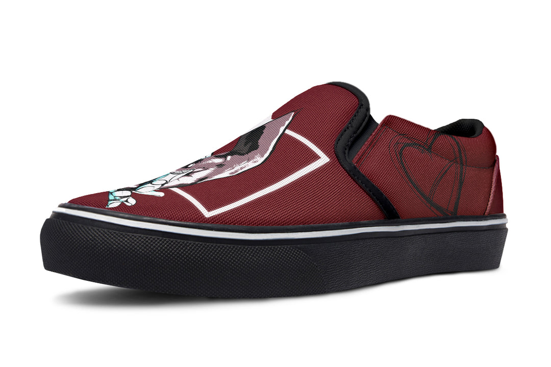 Side profile of the red slip-on sneaker showing heart line art near the heel. The clean black outsole and red canvas upper emphasize the minimalist yet expressive style of the “July” design by Sky Titan Media.