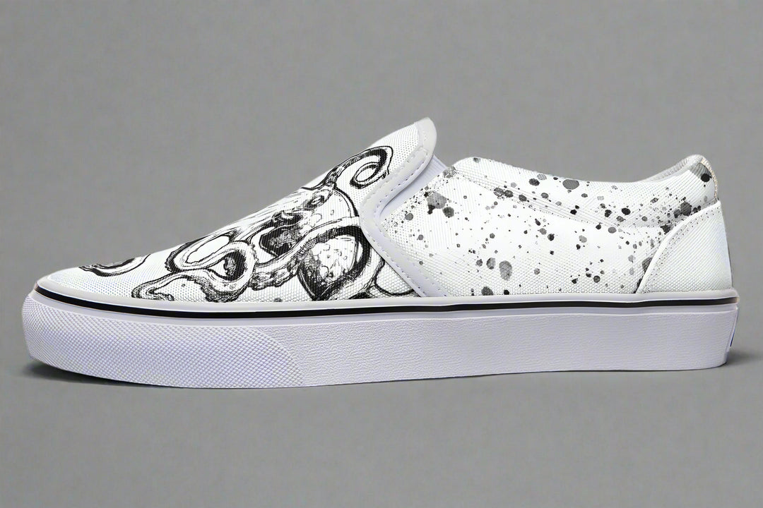 Side profile of Octopus White Edition slip-ons by Sky Titan Media, featuring expressive black artwork over all-white canvas and a matching white sole – designed for sharp, creative simplicity.