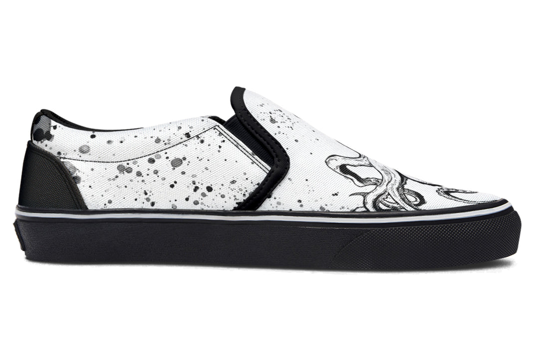 Side view of Sky Titan Media’s Octopus Dual Canvas Edition slip-ons – left shoe in white canvas with black octopus design, right shoe in black canvas with white octopus art, both unified by black soles and creative energy.