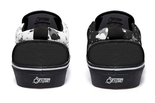 Back view of the Octopus Dual Canvas Edition sneakers showing color inversion between each shoe, with clean heel lines and a shared black sole grounding the creative split.