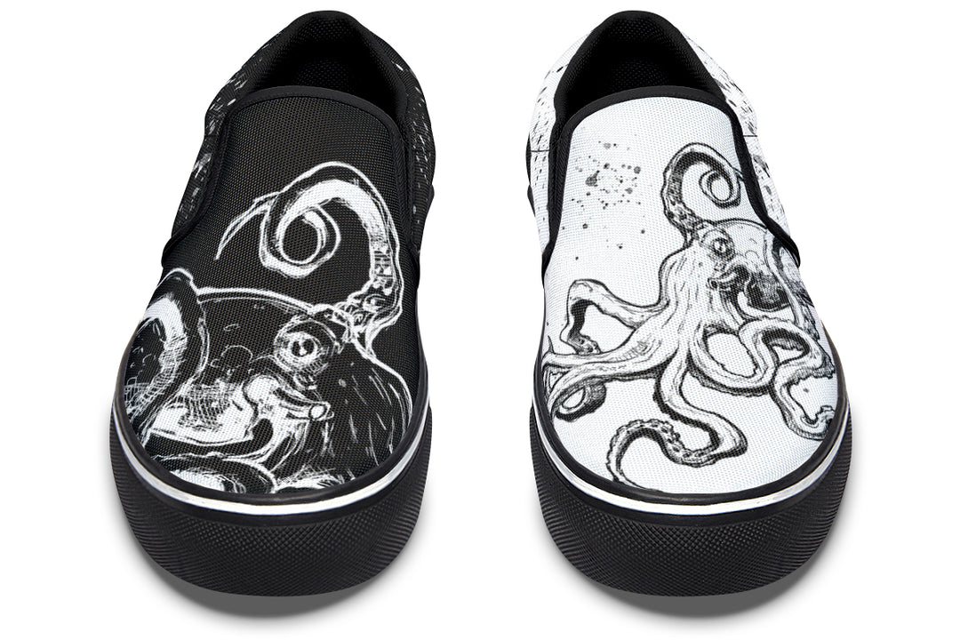 Front-facing view of mismatched Sky Titan Media slip-ons – a high-contrast pair featuring octopus tentacles and paint splashes across black and white canvas, designed to stand out.
