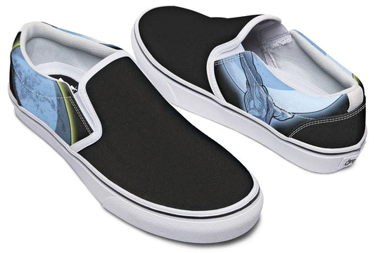 Black slip-on sneakers with white midsoles, inside quarters, and binding, featuring Sky Titan Media’s Skybound design. The left shoe displays a blue-toned Atlas across both outer and inner sides, lifting the sky toward the moon, while the right shoe features a glowing moon with a yellow halo stroke on the outer side, and a Sky Titan logo with the moon on the inner side. — Skybound design by Sky Titan Media, blending mythology-inspired visuals with streetwear rooted in independent music culture.
