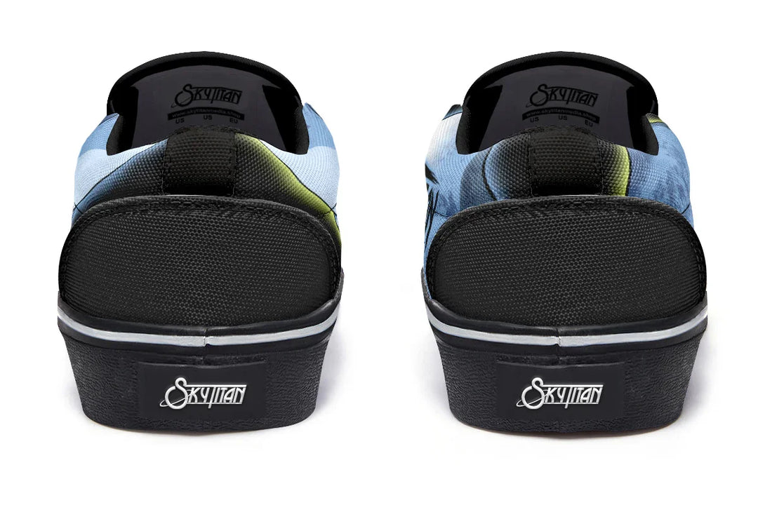 Rear view of Skybound slip-ons with reinforced heel panels and stitched canvas. The mythic Atlas and celestial moon imagery wrap subtly around the back, linking both shoes in a story of burden and elevation. — Skybound design by Sky Titan Media, blending mythology-inspired visuals with streetwear rooted in independent music culture.