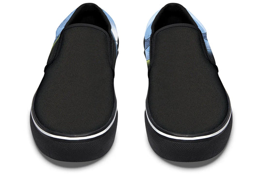 Front view of Skybound slip-on sneakers, featuring smooth black rubber toe caps. The left shoe hints at Atlas’s silhouette, while the right shoe subtly reveals the curved edge of the moon graphic. Black elastic gores and piping frame the structure, letting the mythic details peek through. — Skybound design by Sky Titan Media, blending mythology-inspired visuals with streetwear rooted in independent music culture.